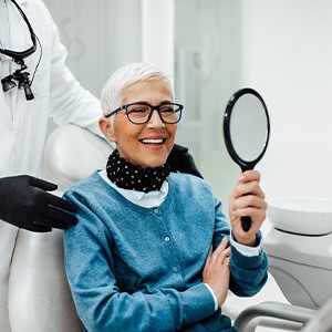 Senior woman smiling while looking at reflection