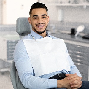 Patient smiling while sitting in treatment chair